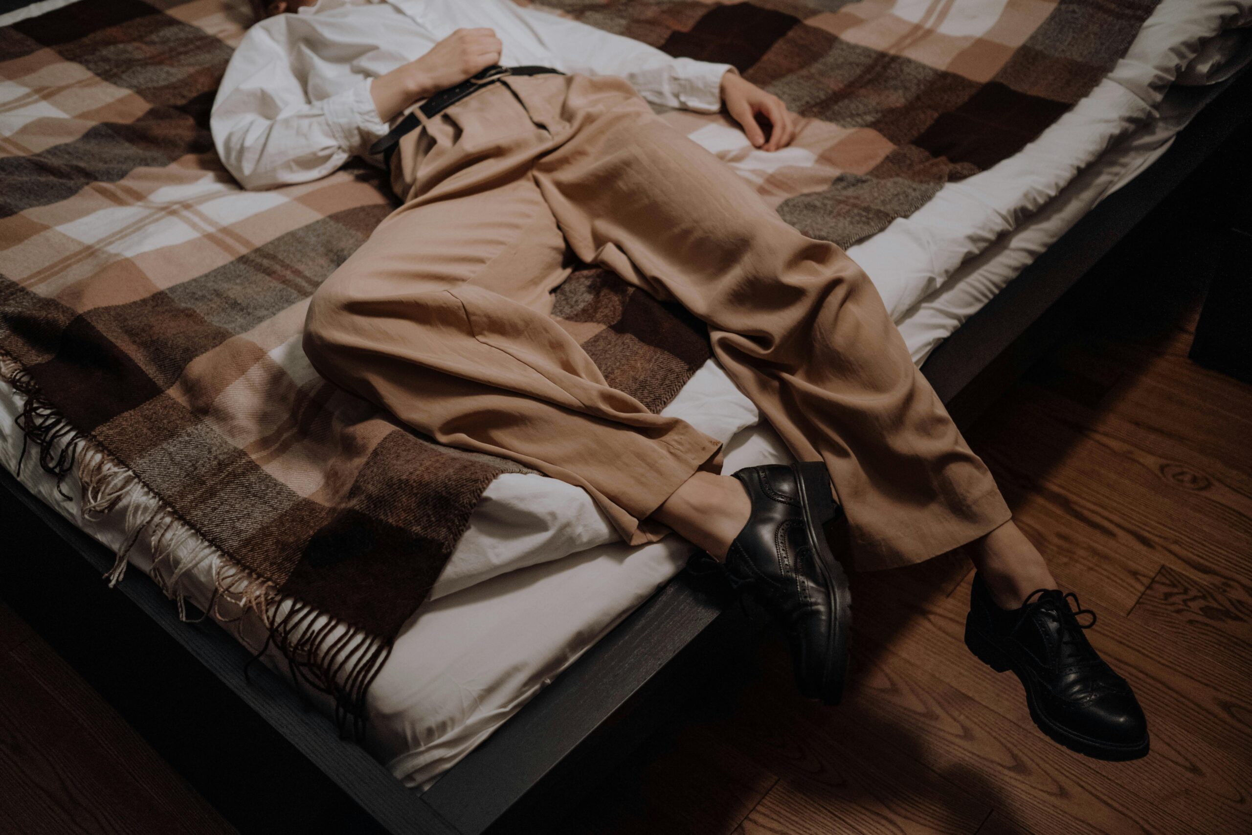pexels-ron-lach-8486171 person laying on a bed diagonally with their head not in frame