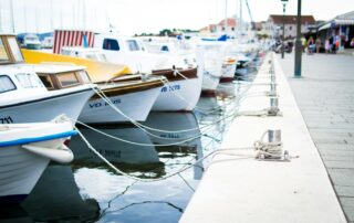 boats securely anchored to a safe harbor