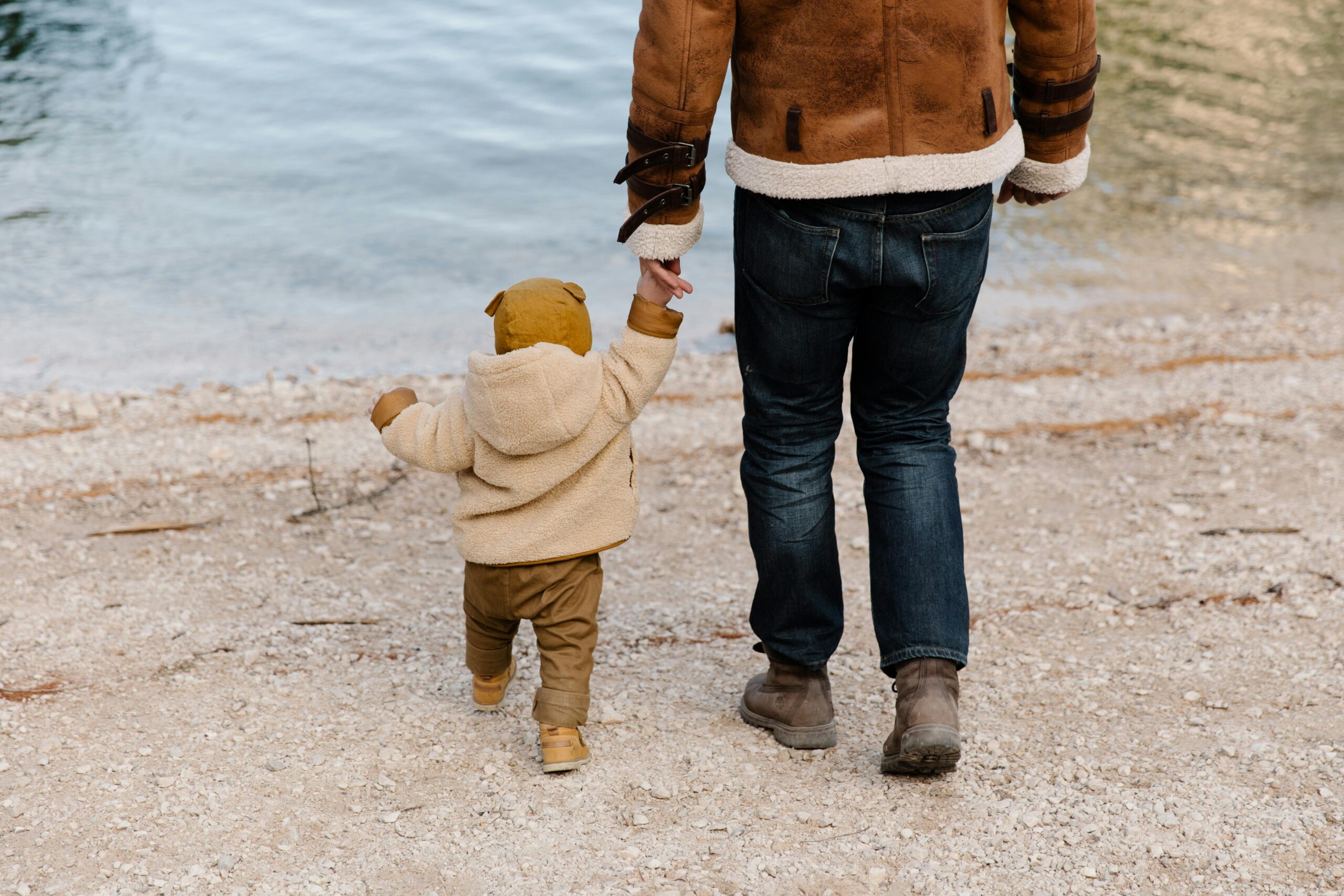 Parent holding a child's hand gently